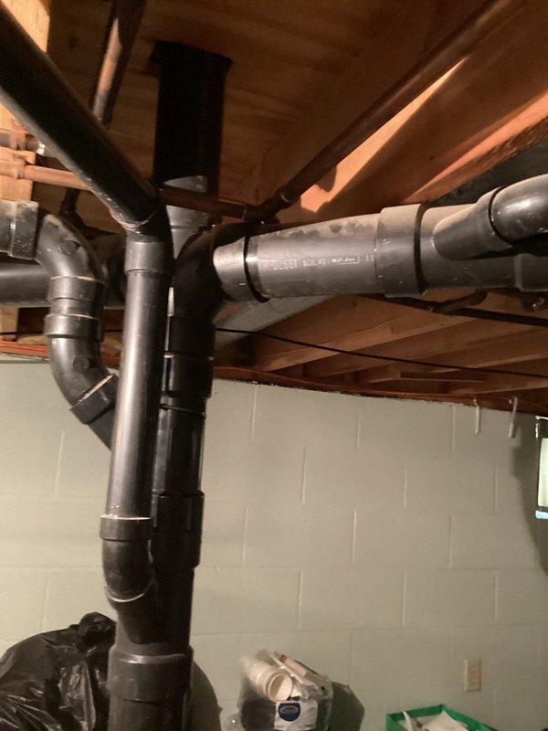 Conducted a complimentary on-site evaluation of existing basement drainage infrastructure to assess compatibility requirements for new toilet installation. Inspected exposed plumbing system including black PVC drainage assemblies and gray PVC supply lines mounted to floor joists, identifying necessary modifications to accommodate updated fixtures. Provided detailed estimate for drainage system reconfiguration to ensure proper waste removal and venting for proposed basement toilet installation.