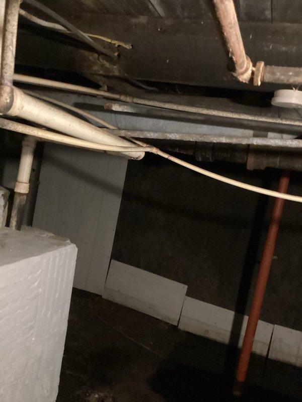 Completed drain unclogging service in basement following initial water removal by previous technician. Cleared obstruction from drainage system and verified proper flow through plumbing lines. Inspected basement utility area including PVC drainage pipes, copper supply lines, and associated mechanical systems to ensure full restoration of drainage function.