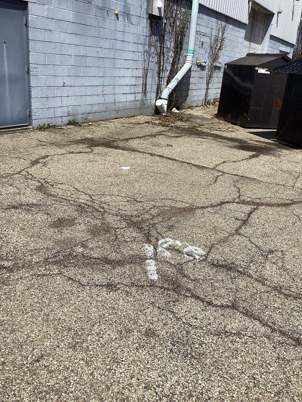 Responded to service call for sewer line obstruction at commercial property. Customer had previously performed camera inspection which identified clog requiring excavation and repair. Conducted on-site assessment of affected area behind building where underground piping is located. Evaluated surface conditions showing significant cracking and existing utility markings, indicating previous ground disturbance. Examined exterior drainage system including exposed PVC piping near building foundation. Documented site conditions including pavement deterioration, wall staining patterns suggesting potential drainage issues, and accessibility constraints due to proximity of dumpster and service entrance. Prepared comprehensive estimate for excavation, pipe repair or replacement, and surface restoration work required to resolve the blockage.