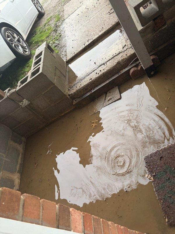 Responded to drainage issue at front entry where clogged floor drain was causing significant water pooling and standing water on concrete porch and steps during rainfall. Deployed jetter equipment to clear the obstruction in the drain line located at the entrance area. Successfully restored proper drainage function, eliminating water accumulation at the doorway and preventing further water damage to the concrete surfaces and foundation area.