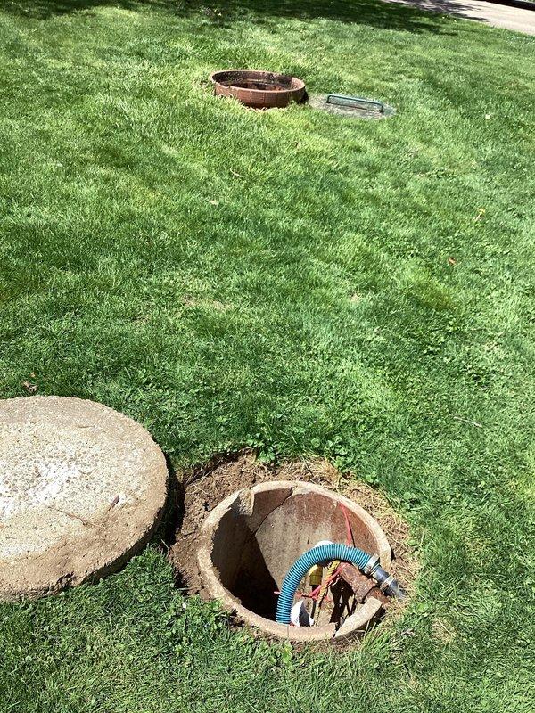 Responded to clogged drain issue in 1954-built home with blockage located under basement floor. Accessed main drain cleanout via exterior yard access point, removed concrete lid, and cleared obstruction using appropriate drain cleaning equipment. Verified proper flow restoration through main line, secured cleanout cover, and restored work area to original condition.