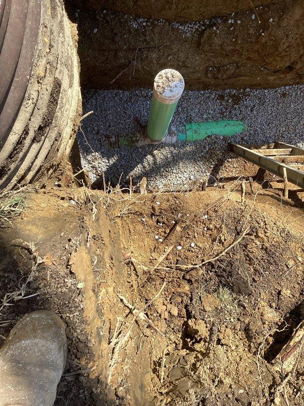 Completed full sewer lateral replacement involving exterior and interior main drain line rehabilitation. Excavated front yard and removed approximately 27'-30' of deteriorated clay piping from house to near road, replacing with new PVC pipe. Installed new riser pipe and cleanout assembly in front of house, backfilled excavation with dirt. Inside basement, jackhammered concrete floor to expose main drain line, removed old cast iron piping and replaced with new PVC. Tied new line into existing PVC main stack and installed additional cleanout for future access. Properly sloped all drainage lines to ensure adequate flow, backfilled interior excavation with dirt, and poured rough concrete patch to restore basement floor. Obtained required exterior sewer lateral replacement permit and coordinated inspection scheduling.