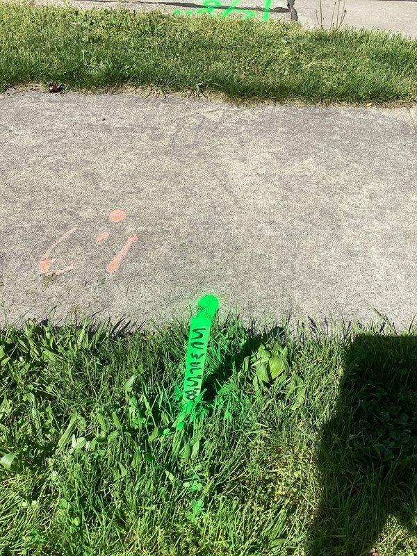 Responded to service call for recurring sanitary sewer line backups at duplex property. Performed free plumbing assessment and marked utility locations on concrete surfaces using spray paint and locator flags in preparation for excavation work. Identified need for camera inspection and excavation of sanitary line to diagnose and repair blockage issues affecting both units.