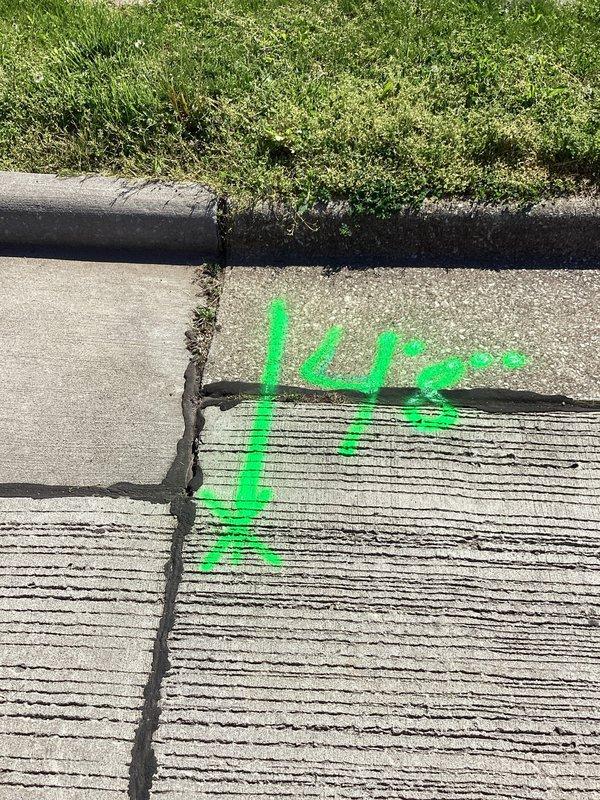 Responded to service call for recurring sanitary sewer line backups at duplex property. Performed free plumbing assessment and marked utility locations on concrete surfaces using spray paint and locator flags in preparation for excavation work. Identified need for camera inspection and excavation of sanitary line to diagnose and repair blockage issues affecting both units.