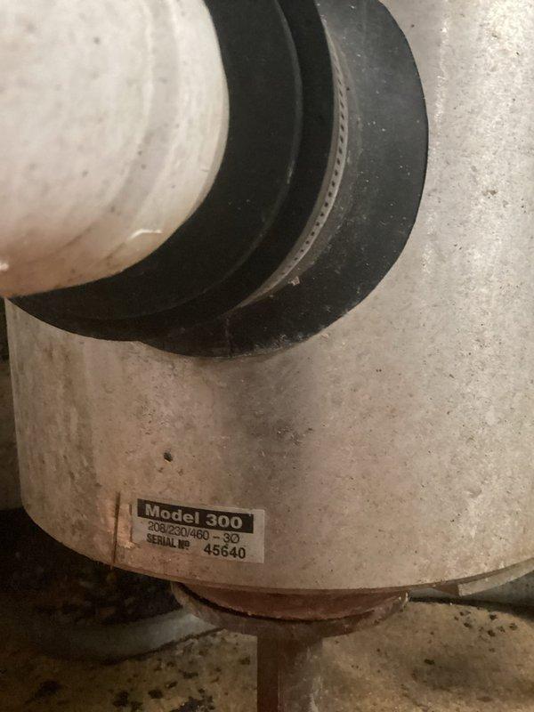 Responded to service call for non-operational commercial garbage disposal unit. Upon inspection, identified Salvajor Model 300 disposal system installed under commercial sink with visible signs of wear and operational failure. Assessed unit condition, documented equipment specifications and installation configuration, and photographed disposal assembly including mounting, drainage connections, and electrical components for service records and future reference.