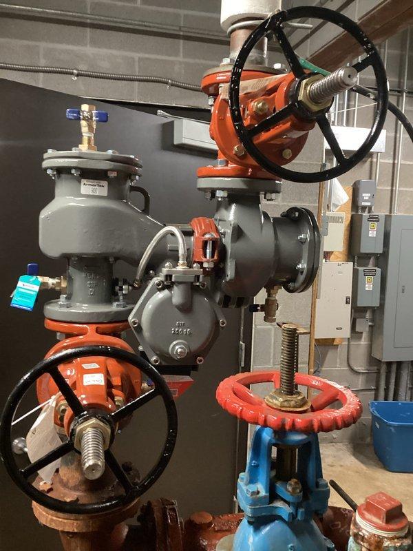 Replaced existing 3-inch backflow prevention assembly that exhibited significant corrosion and deterioration throughout the valve body, flanges, and connection points. The old assembly showed extensive oxidation and compromised integrity that required complete removal and installation of new backflow device with proper shutoff valves, ensuring compliance with plumbing codes and maintaining system protection against water contamination.