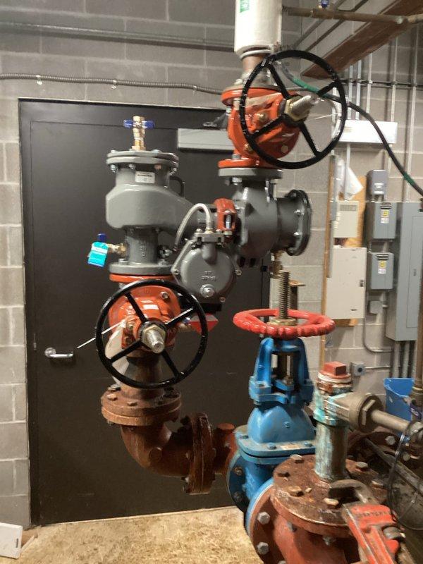 Replaced existing 3-inch backflow prevention assembly that exhibited significant corrosion and deterioration throughout the valve body, flanges, and connection points. The old assembly showed extensive oxidation and compromised integrity that required complete removal and installation of new backflow device with proper shutoff valves, ensuring compliance with plumbing codes and maintaining system protection against water contamination.