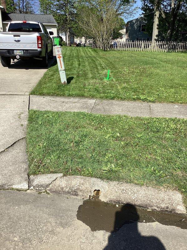 Responded to service call for possible drainage clog affecting sump pump and gutter discharge line running to street at 1977-built residence. Conducted thorough site inspection of exterior drainage system and marked key access points in yard for assessment. Photographed existing conditions including surface water pooling on sidewalk and marked utility/drainage locations. Determined scope of work required for proper diagnosis and provided customer with assessment findings and recommendations for drain line clearing and restoration.