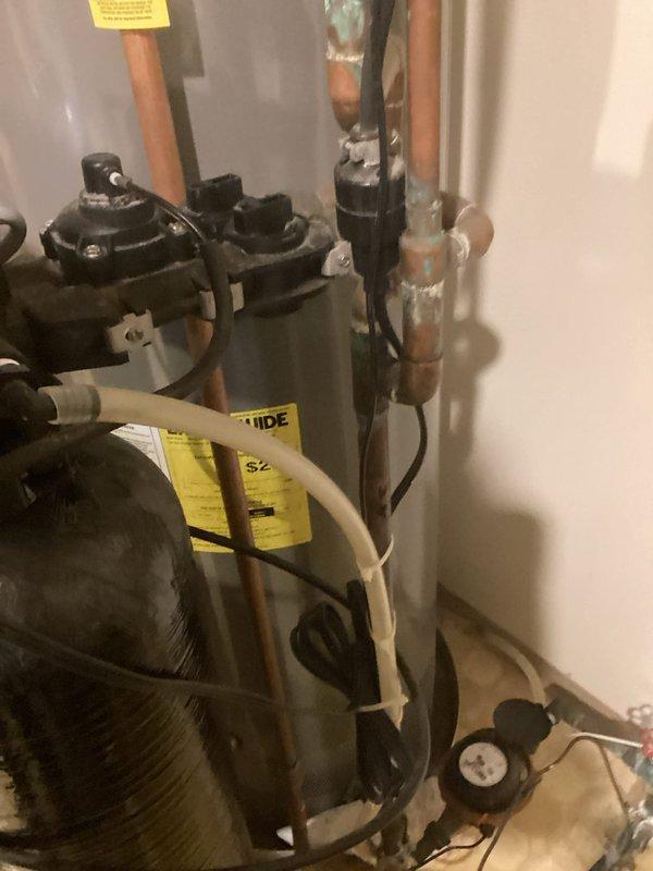 Provided quote for complete removal of existing water softener system and replumbing of water supply lines. Assessed current plumbing configuration including copper supply lines, water heater connections, and existing softener bypass setup to determine scope of work and materials required for restoration to standard municipal water supply.