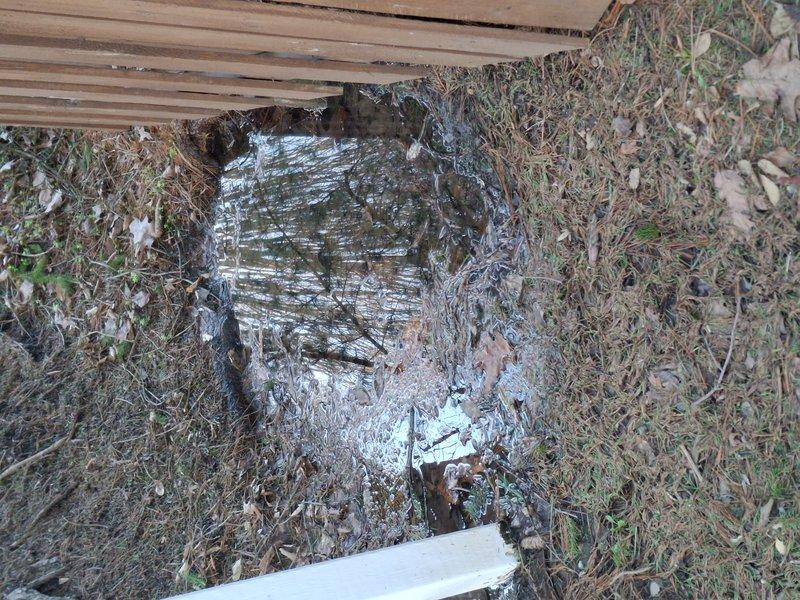 Responded to flooding issues affecting both the French drain area and adjacent backyard. Upon arrival, observed standing water pooling near foundation with deteriorated drainage components and accumulated debris obstructing proper water flow around the building perimeter. Documented existing conditions showing compromised lattice skirting, degraded structural elements, and inadequate drainage function requiring specialized attention from drainage contractors for comprehensive system assessment and repair.