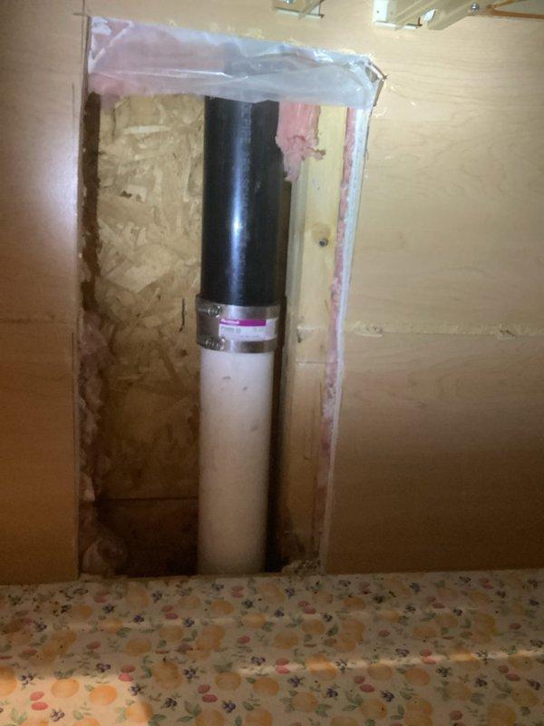 Responded to main drain line concern at 30-year-old residential property. Performed video camera inspection of main sewer line from basement cleanout to identify blockage or structural issues in the line going into ground. Inspection revealed aging cast iron and PVC drain assembly with rubber coupling connections at the main stack. Accessed plumbing through existing wall opening showing vertical drain configuration with proper venting. Documented current condition of drainage system including concrete foundation penetration point and basement piping layout. Main drain assembly showed typical age-related wear but remained structurally sound with no immediate failures detected in visible sections.