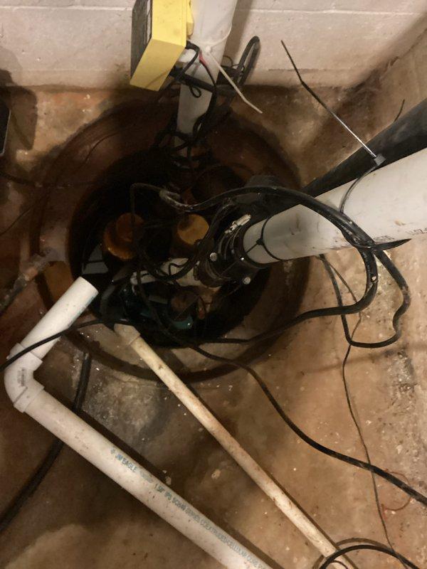 Responded to service call for sump pump leaking from bottom during cycle operation. Upon inspection, identified active leak at base of pump housing within sump pit. Assessed pump installation, discharge piping connections, and check valve assembly for proper operation and seal integrity. Documented existing conditions showing mineral deposits and water staining on pit walls, indicating previous moisture issues. Evaluated electrical connections, pump controller functionality, and PVC discharge line configuration to determine source of leak and recommend appropriate repair or replacement options to prevent continued water intrusion during pump cycling.