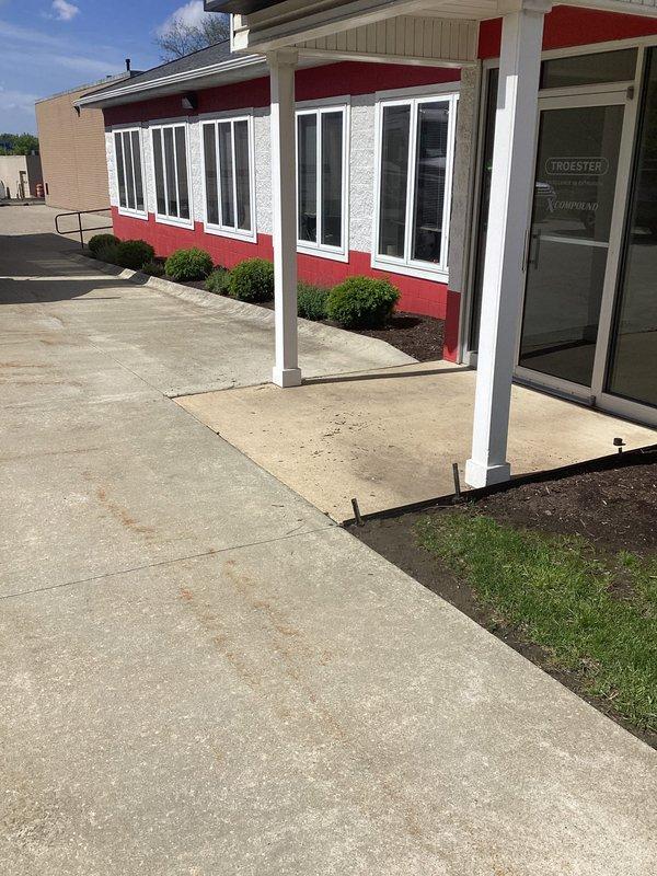 Conducted complimentary site assessment for commercial property experiencing water drainage issues along building perimeter. Evaluated existing landscape and grading conditions, documenting areas where surface water accumulates near foundation. Photographed current site conditions including building exterior, sidewalk areas, and landscaped zones to develop French drain installation proposal that will redirect groundwater away from structure.