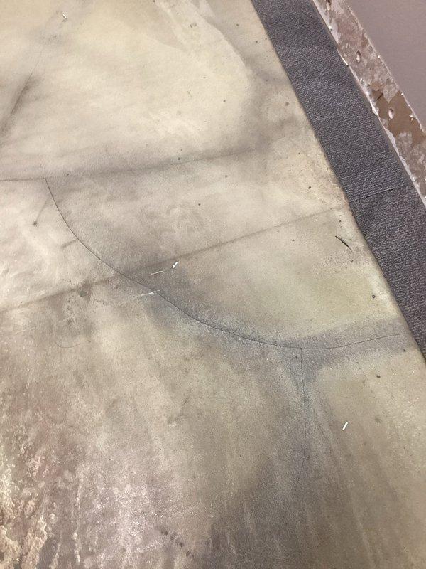 Responded to emergency call for water intrusion through concrete floor slab in commercial facility. Upon arrival, observed active water seepage penetrating through multiple cracks in the floor surface, with visible moisture damage and staining patterns on concrete indicating ongoing subsurface leak from pressurized water line. Documented extensive water damage affecting flooring and adjacent wall areas, with evidence of prolonged moisture exposure causing deterioration to painted surfaces and baseboards. Traced leak source to compromised underground piping beneath slab, likely due to pipe deterioration or joint failure based on age of existing plumbing system. Coordinated with facilities management to assess full extent of water damage and determine additional affected areas beyond initially reported room.