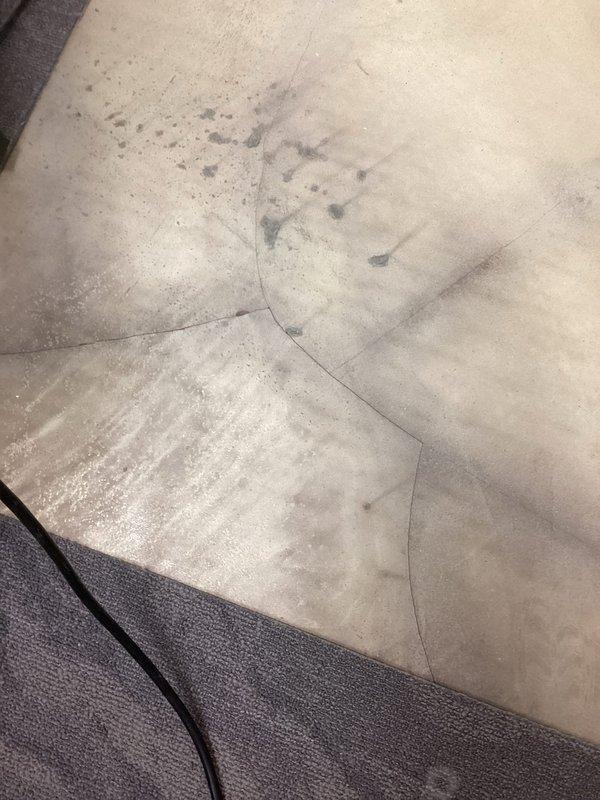 Responded to emergency call for water intrusion through concrete floor slab in commercial facility. Upon arrival, observed active water seepage penetrating through multiple cracks in the floor surface, with visible moisture damage and staining patterns on concrete indicating ongoing subsurface leak from pressurized water line. Documented extensive water damage affecting flooring and adjacent wall areas, with evidence of prolonged moisture exposure causing deterioration to painted surfaces and baseboards. Traced leak source to compromised underground piping beneath slab, likely due to pipe deterioration or joint failure based on age of existing plumbing system. Coordinated with facilities management to assess full extent of water damage and determine additional affected areas beyond initially reported room.