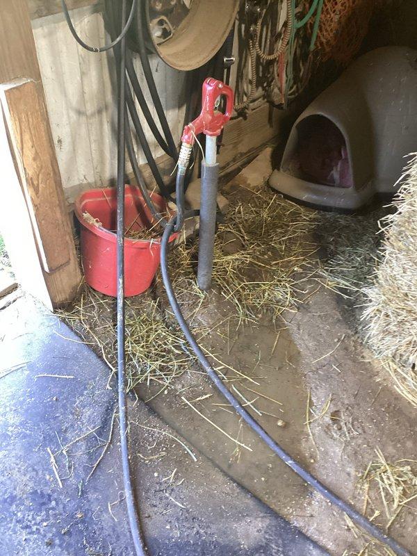Responded to water leak at hand pump well system previously installed in barn. Upon arrival, found active leak causing flooding in work area with water pooling on concrete floor around pump base. Inspected hand pump assembly and associated plumbing connections for source of leak. Identified compromised seal or fitting connection at pump body. Disassembled affected components, replaced faulty seals and gaskets, and reassembled hand pump system. Tested pump operation to verify proper function and confirmed leak was resolved with no further water discharge. Advised on routine maintenance to prevent future seal deterioration.