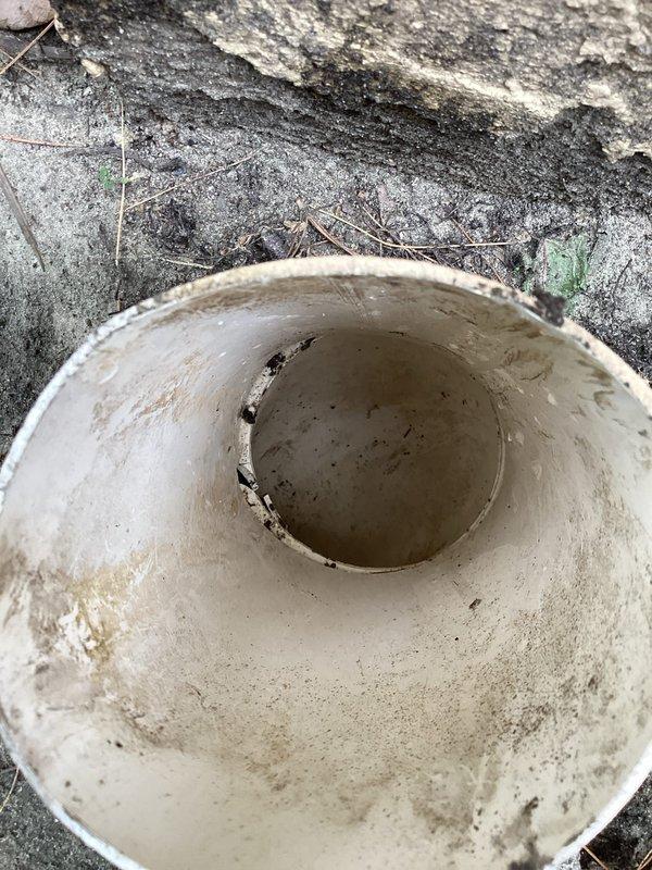 Responded to recurring drainage issue where garage flooding returned after previous jetting service when heavy rain occurred. Performed secondary high-pressure water jetting of drainage line to clear persistent blockage and restore proper flow. Documented exterior drainage area and collected water sample showing sediment and debris present in system.