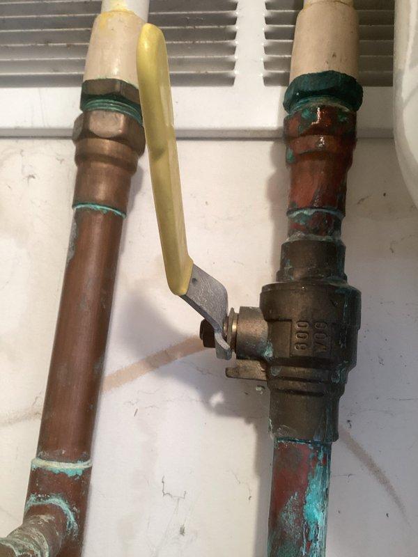 Responded to utility room water leak caused by failing main ball valve feeding the unit. Replaced corroded brass ball valve showing significant deterioration and green patina buildup on copper connections. Installed new Zurn WXTP-18 thermal expansion tank to replace failing unit, connecting to existing copper supply lines with proper shut-off valves and fittings to ensure system integrity and prevent future pressure-related issues.
