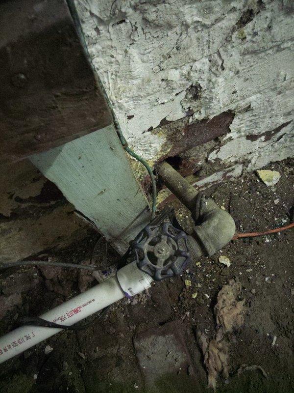 Responded to vacant unit requiring meter horn installation to facilitate water service restoration by municipal utility. Upon arrival, accessed property via lockbox and located water meter assembly in deteriorated basement/crawl space area showing extensive water damage and long-term neglect. 

Installed new meter horn on existing water meter per code requirements to allow city water department to restore service to the property. Completed installation using appropriate fittings and connections to integrate with existing white PVC supply piping and corroded gate valve assembly. Verified proper alignment and secure mounting of meter horn component to meet municipal inspection standards for service reconnection.