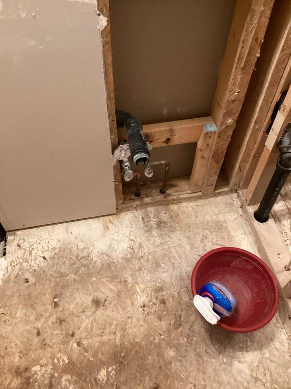 Responded to emergency call for burst pipe in half bathroom that caused extensive water damage throughout the home. Upon arrival, found significant structural damage requiring removal of drywall and exposure of wall framing to access failed plumbing components. Assessed water-damaged subflooring in affected area and identified compromised toilet flange and supply line requiring attention. Installed temporary shut-off valve to stop active water flow and prevent further damage. Removed saturated building materials and documented extent of damage to framing, subflooring, and plumbing fixtures. Coordinated with property owner regarding scope of repairs needed, including subfloor replacement, drywall restoration, and plumbing system repairs before finish work can proceed.
