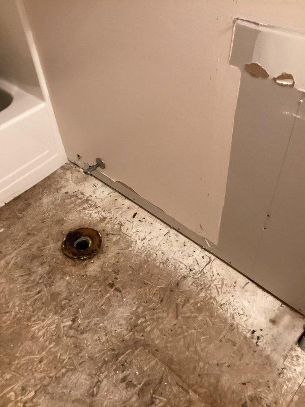 Responded to emergency call for burst pipe in half bathroom that caused extensive water damage throughout the home. Upon arrival, found significant structural damage requiring removal of drywall and exposure of wall framing to access failed plumbing components. Assessed water-damaged subflooring in affected area and identified compromised toilet flange and supply line requiring attention. Installed temporary shut-off valve to stop active water flow and prevent further damage. Removed saturated building materials and documented extent of damage to framing, subflooring, and plumbing fixtures. Coordinated with property owner regarding scope of repairs needed, including subfloor replacement, drywall restoration, and plumbing system repairs before finish work can proceed.
