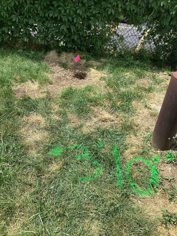 Completed drain cleaning service at a 70-year-old residential property as a scheduled revisit. Accessed exterior drainage system, located and cleared clogged line using professional rodding equipment. Utility markings and excavation flags visible in service area indicated coordination with underground utility locations prior to work. Successfully restored proper drainage flow and verified system operation before departure.