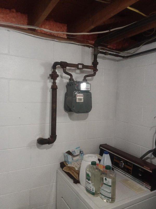 Installed 85 feet of 1.5-inch gas line from an interior tap location within the basement utility area. The new gas piping was routed through the ceiling joists alongside existing plumbing and HVAC infrastructure, terminating at the gas meter mounted on the concrete block wall. All connections were properly secured and tested to ensure safe operation and code compliance.