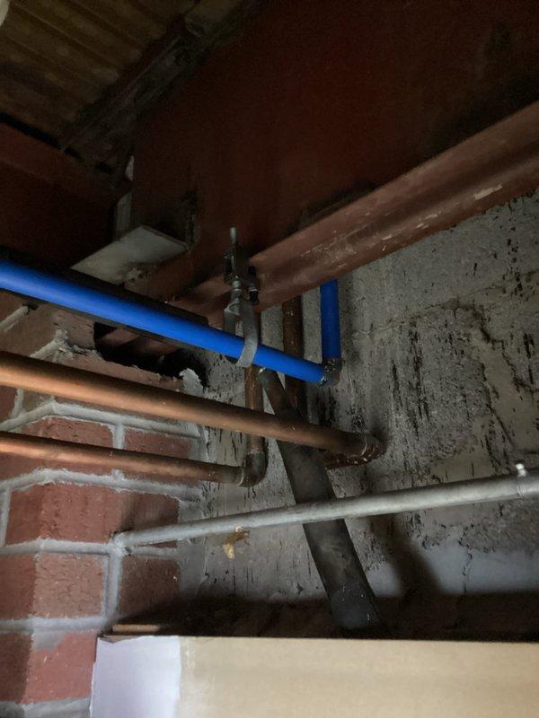Completed installation of 1" Wilkins backflow prevention device in basement plumbing system. Modified existing piping configuration to accommodate backflow preventer and added shut-off valve for system isolation. Routed new drain line as specified. Wall opening created for access; drywall restoration to be completed by property owner. Performed vacuum extraction and mechanical snaking of trough drain line to discharge pit to clear obstruction and restore proper drainage flow. Backflow device testing completed per regulatory requirements to ensure proper operation and compliance.