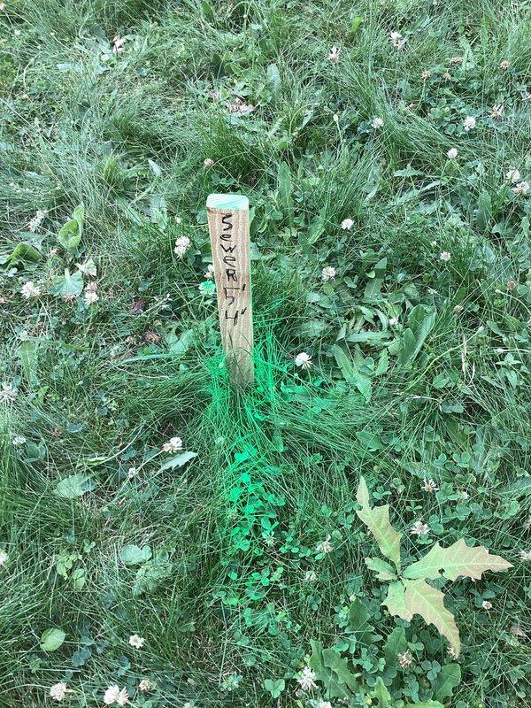 Responded to service call for main drain cleanout during morning hours. Located main sewer cleanout access point in front yard area, which was marked with utility stake and spray paint indicators. Excavated soil around cleanout access as needed to expose the cleanout cap. Successfully cleared blockage from main drain line using professional drain cleaning equipment. Verified proper flow and drainage through main sewer line upon completion. Restored work area and ensured cleanout remained accessible for future maintenance needs.