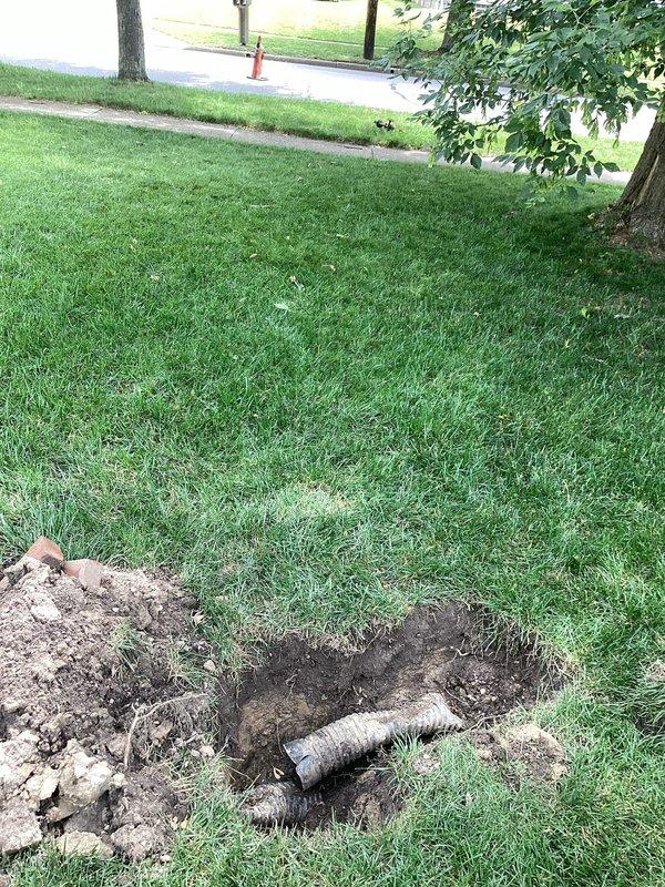 Responded to service call for clogged downspout causing water drainage issues into yard and basement. Upon arrival, performed diagnostic assessment and located underground drainage system failure. Excavated affected areas of lawn to expose buried corrugated drainage pipe and compromised downspout connection. Identified blockage and improper drainage routing causing water to pool in yard and infiltrate basement area. Cleared obstruction from drainage line, verified proper flow, and ensured downspout system was redirected to discharge water away from foundation and living spaces. Backfilled excavated areas and restored lawn surface to original condition.