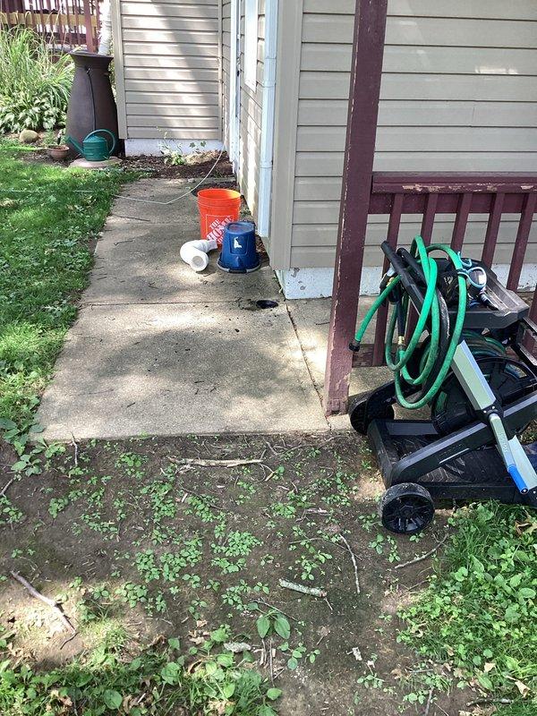 Responded to a backup in a buried corrugated downspout drain with an unknown discharge point. Located and marked the underground drainage path using utility marking paint to identify the pipe route across the lawn area. Deployed professional drain cleaning equipment including power auger and inspection tools to assess and clear the blockage in the corrugated piping system, restoring proper drainage flow from the downspout.