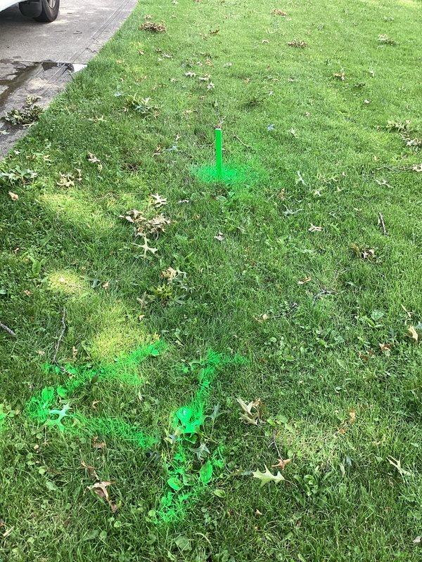 Responded to a backup in a buried corrugated downspout drain with an unknown discharge point. Located and marked the underground drainage path using utility marking paint to identify the pipe route across the lawn area. Deployed professional drain cleaning equipment including power auger and inspection tools to assess and clear the blockage in the corrugated piping system, restoring proper drainage flow from the downspout.