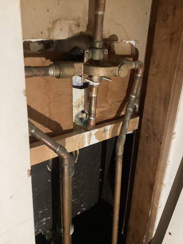 Responded to service call for bathroom faucet repair and sewer line inspection. Replaced broken faucet handle in bathroom fixture. Inspected exposed plumbing infrastructure including copper supply lines, brass valve assembly, and drainage piping from sink to basement level. Assessed condition of aging plumbing components, noted water staining on surrounding wall surfaces, and verified proper operation of drainage system and HVAC condensate lines in basement area.