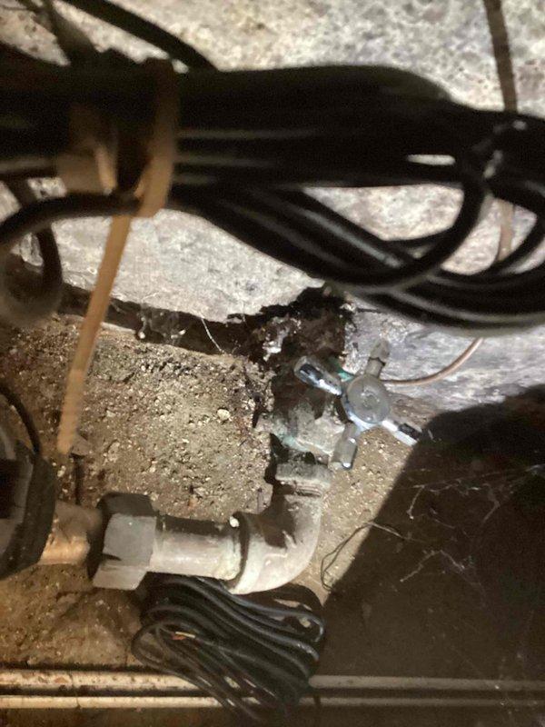 Responded to service call for bathroom faucet repair and sewer line inspection. Replaced broken faucet handle in bathroom fixture. Inspected exposed plumbing infrastructure including copper supply lines, brass valve assembly, and drainage piping from sink to basement level. Assessed condition of aging plumbing components, noted water staining on surrounding wall surfaces, and verified proper operation of drainage system and HVAC condensate lines in basement area.