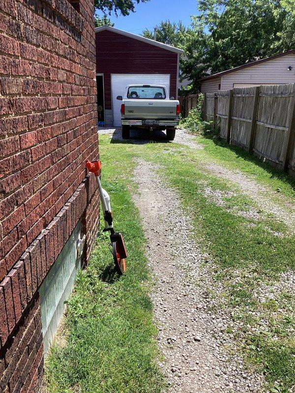Conducted site evaluation for installation of new drain lines to residential property. Assessed access route through narrow side yard between structures, noting gravel driveway conditions and clearances for equipment and materials. Documented existing utility locations including gas shutoff valve on foundation wall. Evaluated pathway constraints including wooden privacy fencing, established vegetation, and proximity to adjacent buildings. Determined optimal routing for drain line installation from house to connection point, accounting for grade requirements and underground obstacles. Provided comprehensive estimate for drain line installation project.