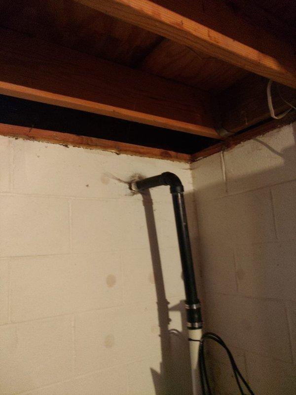 Provided free estimate for sump pump replacement in basement utility area. Assessed existing sump pump system, drainage infrastructure, and vertical discharge piping running from floor to ceiling, noting staining and water damage on concrete floor surrounding pump base. Customer considering coordinating sump pump replacement with previously estimated downspout work.