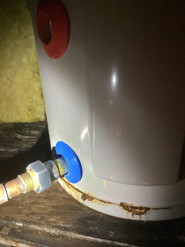 Responded to service call for commercial hot water heater assessment. Upon inspection, found existing 10-year-old tank-style water heater with severe corrosion and rust deterioration at the tank bottom and lower connection points. Documented extensive rust staining and compromised tank integrity indicating imminent failure. Photographed existing installation including copper supply piping, brass fittings, and current mounting configuration. Provided quote for complete water heater replacement due to non-repairable tank corrosion.