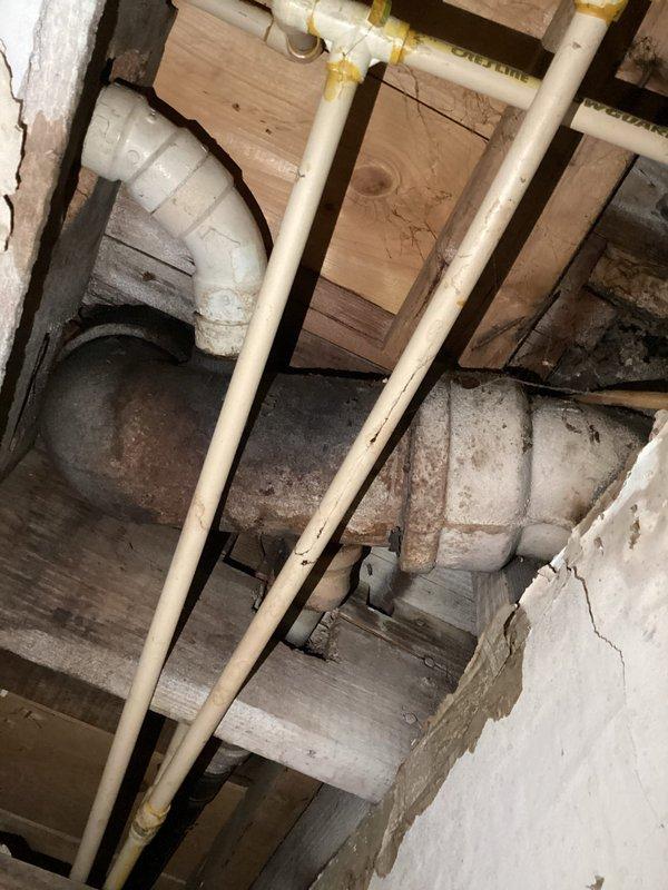 Responded to clogged basement drain and backup situation. Upon arrival, accessed the main drain cleanout system located in the basement area beneath floor joists. Performed thorough inspection of the drainage system, including white PVC drain lines and connecting pipes running through the floor structure. Successfully cleared the blockage in the main drain line, restoring proper flow and eliminating the backup condition. Verified system operation and confirmed all drains were functioning correctly before completing the service.