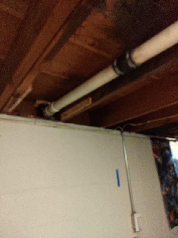 Provided estimate for comprehensive plumbing installation project involving new supply and drain lines for bathroom and kitchen fixtures with connection to existing septic system. Inspected exposed basement ceiling area and documented existing plumbing infrastructure, including PVC drain lines and copper water supply lines secured to floor joists. Assessed routing requirements for new plumbing runs through accessible utility spaces to accommodate planned fixture installations and proper septic tie-in.