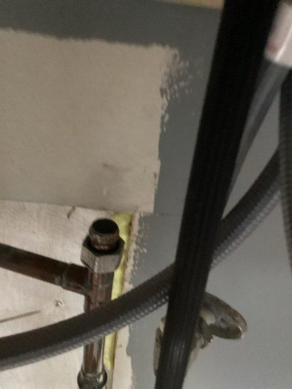 Responded to water leak emergency under kitchen sink with crawlspace access only. Upon arrival, located missing shut-off valve in crawlspace after water company performed main shut-off. Accessed crawlspace to identify source of leak, which was traced to failed copper pipe connections and compromised fittings beneath kitchen area. Repaired copper piping assembly by replacing damaged compression fittings and reinstalling sections with proper connections. Installed new insulated components and secured all pipe junctions to prevent future leaks. Tested system for proper water flow and verified all connections were watertight before restoring water service.