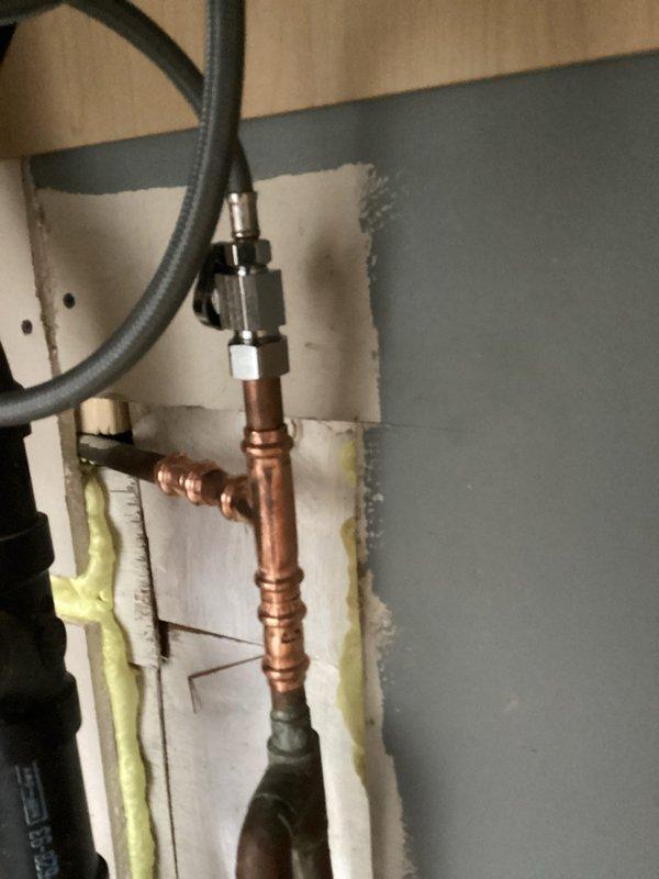 Responded to water leak emergency under kitchen sink with crawlspace access only. Upon arrival, located missing shut-off valve in crawlspace after water company performed main shut-off. Accessed crawlspace to identify source of leak, which was traced to failed copper pipe connections and compromised fittings beneath kitchen area. Repaired copper piping assembly by replacing damaged compression fittings and reinstalling sections with proper connections. Installed new insulated components and secured all pipe junctions to prevent future leaks. Tested system for proper water flow and verified all connections were watertight before restoring water service.