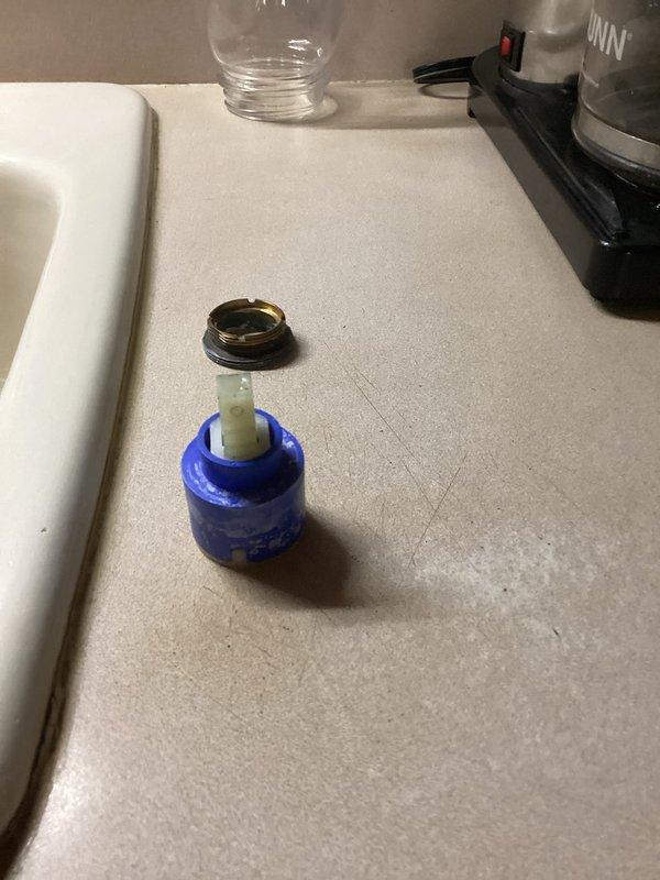 Completed follow-up repair on kitchen sink single-handle faucet that was dripping due to faulty cartridge. Previous service visit had identified the issue but required ordering specific replacement parts. Disassembled faucet handle and escutcheon to access valve assembly, removed worn cartridge, and installed new OEM replacement cartridge with seals. Reassembled faucet components, tested hot and cold water operation, and verified complete elimination of drip with no leaks detected at connections.