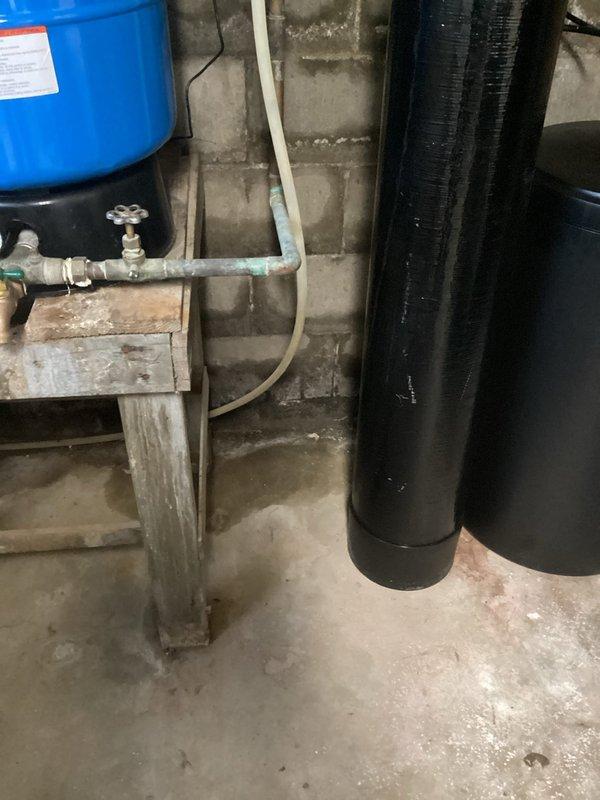 Responded to drainage issue where previous broken pipe repair had been completed, but water flow had created a trench causing basement water infiltration. Inspected basement mechanical area and plumbing system, including water treatment equipment, pressure tank, and associated piping. Assessed drainage patterns and water entry points to determine proper remediation approach for preventing further basement water intrusion from yard runoff.