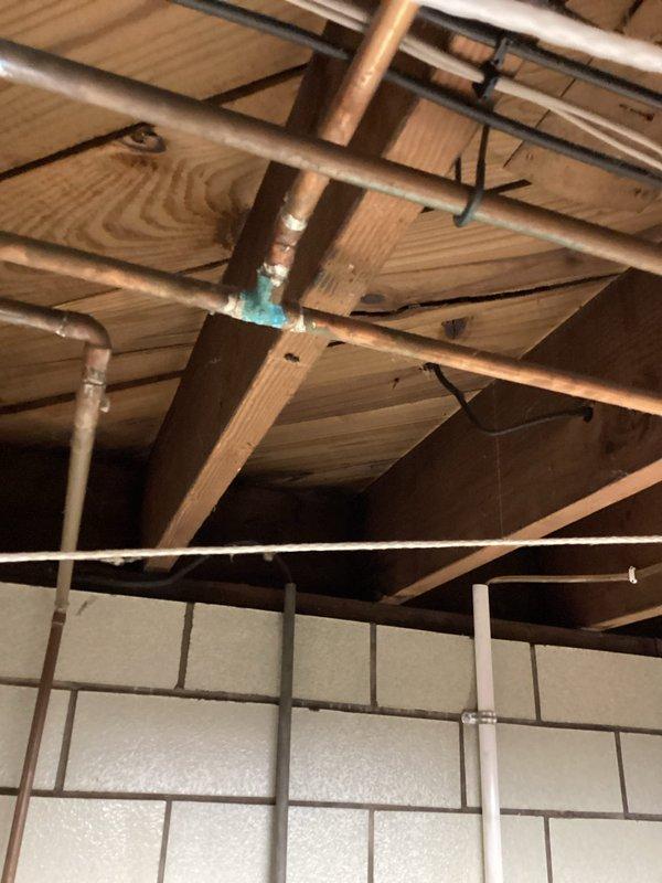 Completed comprehensive plumbing inspection focusing on lead pipe assessment throughout the property. Inspected exposed basement plumbing infrastructure, identifying copper piping with visible corrosion and verdigris buildup at connection points near ceiling joists, along with mixed pipe materials including PVC drainage lines. Documented existing plumbing conditions and provided estimate for potential lead pipe replacement where applicable.