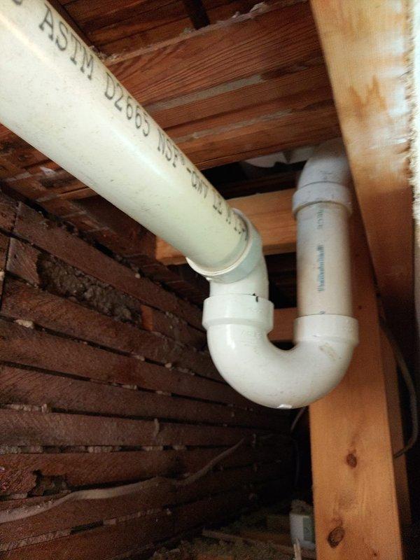 Replaced deteriorated cast iron stack from second floor to basement with 4" PVC pipe and fittings. Installation included proper drainage configuration with P-trap assembly in attic space and vertical drain line through floor joists to basement level. All connections secured to structural elements per code requirements, utilizing appropriate couplings and elbow fittings to ensure proper flow and venting.