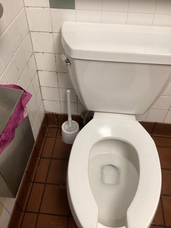 Responded to water leak affecting multiple apartments with reported leaking between dishwasher area and bathroom wall. Upon arrival, conducted thorough inspection of bathroom plumbing fixtures and accessible wall cavities to locate source of water intrusion. Examined toilet connections, supply lines, and drain piping in tiled bathroom area. Documented existing conditions with photographic evidence showing bathroom fixtures, tile work, and floor drain for assessment purposes. Located and repaired leak source, restoring proper water integrity to affected plumbing system and preventing further water damage between adjacent units.