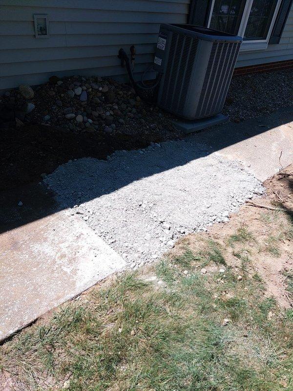 Completed downspout repair and drainage system restoration per approved proposal. Excavated and exposed existing PVC drainage line running from the building foundation, replaced damaged sections of downspout piping, and properly graded the area to ensure optimal water flow away from the structure. Backfilled excavation with appropriate materials, restored landscaping around HVAC condenser unit, and verified system functionality through water flow testing.