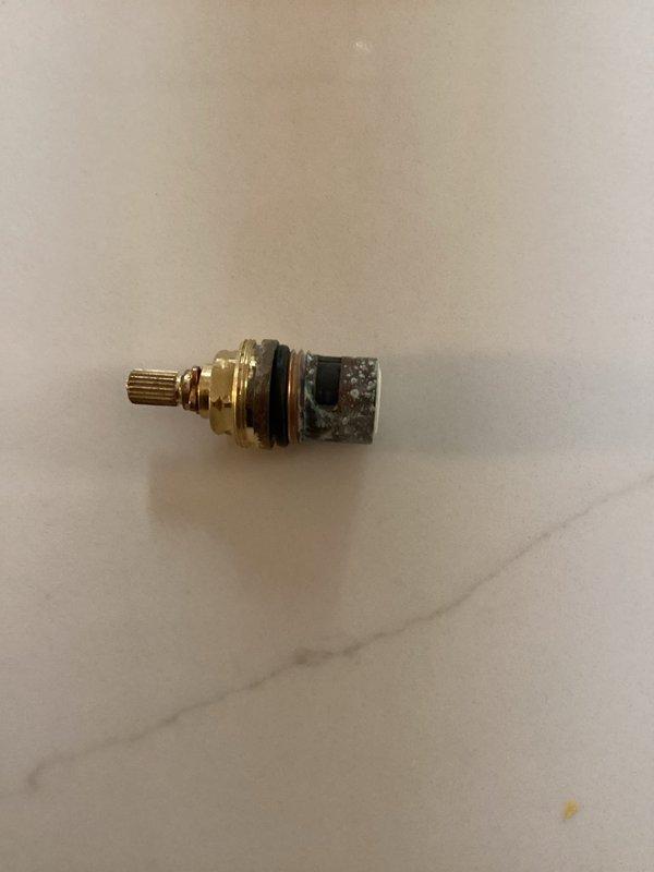 Responded to a leaking kitchen faucet in a 99-year-old home. Upon inspection, identified a failed cartridge valve with deteriorated O-rings and mineral buildup causing the leak. Removed the old cartridge, which showed significant corrosion and calcium deposits consistent with the age of the plumbing system. Installed a new replacement cartridge with fresh seals to restore proper function and eliminate the leak. Tested the faucet operation to confirm no drips and proper water flow. Documented the work with photos of the removed cartridge showing the extent of wear and the completed installation.