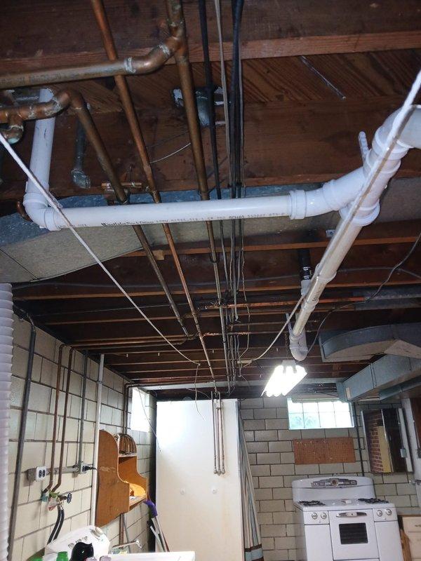 Replaced a section of the main drain stack with 4" PVC pipe in the basement. Cut access through the back of the lavatory cabinet to tie the 1½" PVC lav drain line into the vent system and connect to the new stack. Installed a new lift and turn tub shoe assembly to properly tie in the bathtub drain. Snaked the kitchen sink drain line from the basement cleanout to clear the blockage. Replaced both straight stop angle valves to ensure proper water supply shutoff capability.