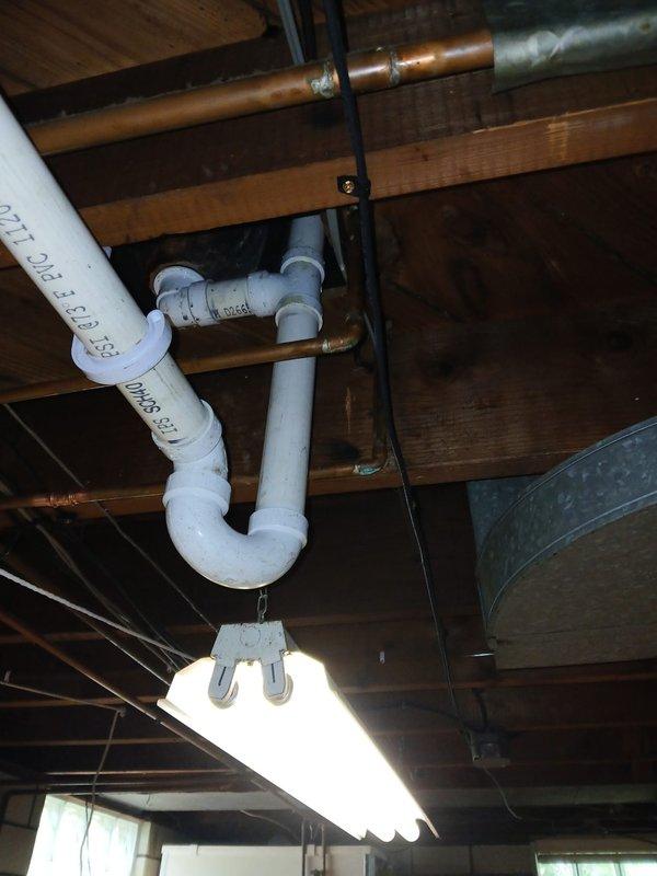 Replaced a section of the main drain stack with 4" PVC pipe in the basement. Cut access through the back of the lavatory cabinet to tie the 1½" PVC lav drain line into the vent system and connect to the new stack. Installed a new lift and turn tub shoe assembly to properly tie in the bathtub drain. Snaked the kitchen sink drain line from the basement cleanout to clear the blockage. Replaced both straight stop angle valves to ensure proper water supply shutoff capability.